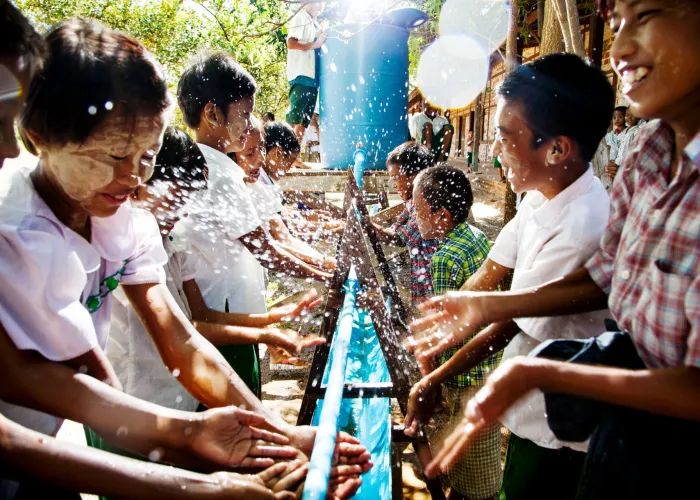 In mid-August 2015 in Myanmar, fourth-grade students from Hnen Ser Kyin Middle School wash their hands at a community water point in the village of Hnen Ser Kyin, Magway Region. A water, sanitation and hygiene (WASH) programme set up by UNICEF and the Department of Rural Development (part of the Ministry of Livestock Fisheries and Rural Development) promotes good hygiene and sanitation practices in the village.